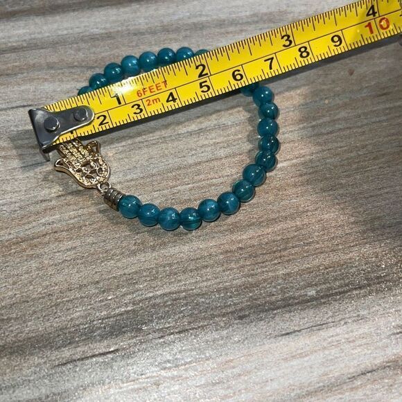 Light Blue Bead Stretch Bracelet with Gold Tone Hamza Hand - Picture 6 of 7